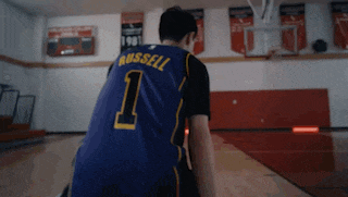 a basketball player wearing a blue jersey with the number 1 on the back
