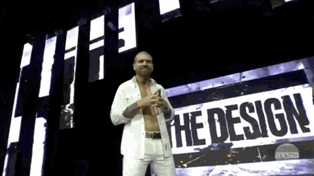 a shirtless man stands in front of a sign that says " the design "