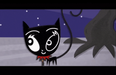 a black cat with a red scarf around its neck is standing in front of a tree