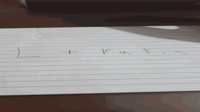 a person is writing on a piece of paper with a black pen .