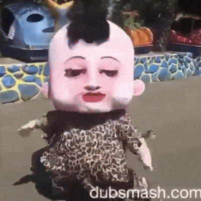 a doll with a big head and a leopard print dress .