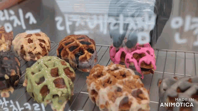 a variety of waffles are displayed in a display case with the words made in animatica on the bottom