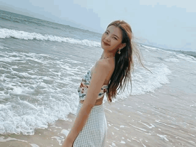 waves crashing on a sandy beach in the ocean