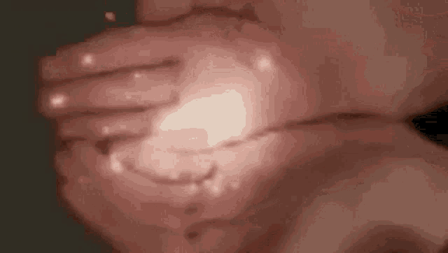 a close up of a person holding a light in their hand