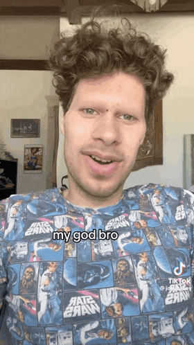 a man with curly hair wearing a star wars shirt says my god bro