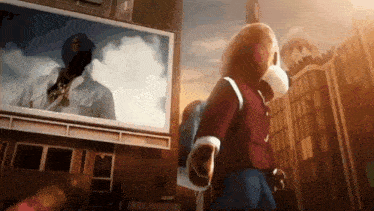 a teddy bear is standing in front of a large billboard with a picture of a man on it .