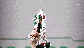 a person is holding a toy gun in their hand and it is glowing green .
