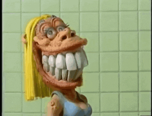 a cartoon character with a big smile on her face is standing in front of a green tiled wall .