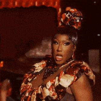a drag queen with a hat on her head and a necklace on her neck