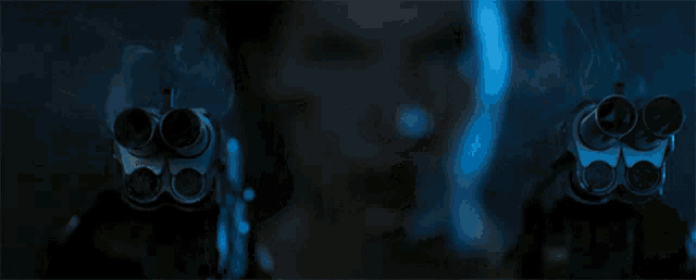 a close up of a person holding a gun with smoke coming out of it