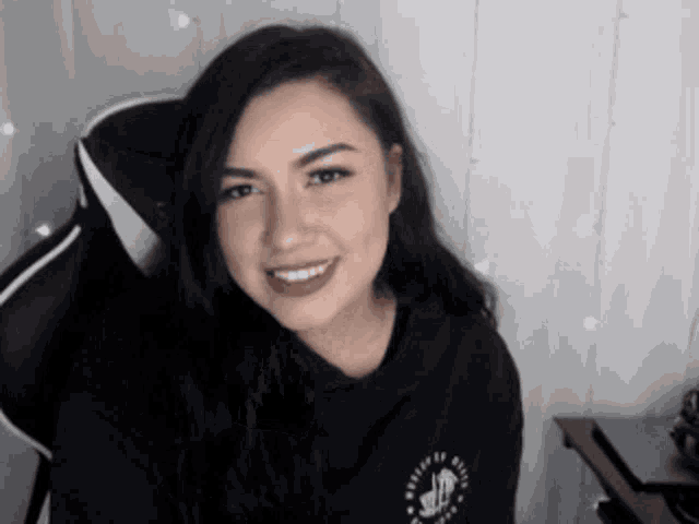 a woman wearing a black shirt that says believe in yourself