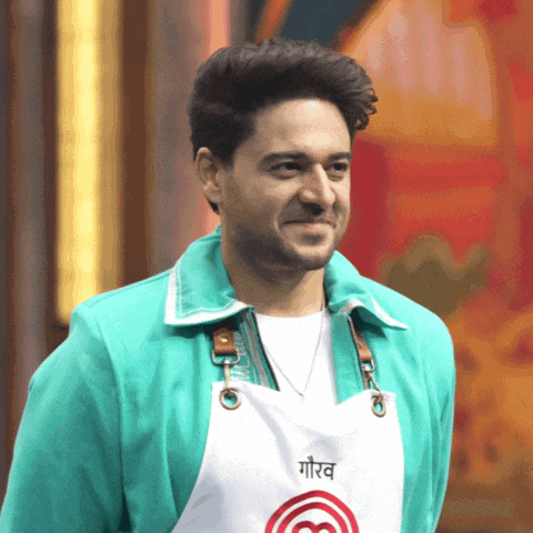 a man wearing a green jacket and an apron that says ' goerv ' on it