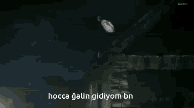 a person standing in front of a building with the words hocca galin gidiyom bn written on the bottom