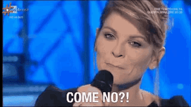 a woman is holding a microphone and saying come no ?