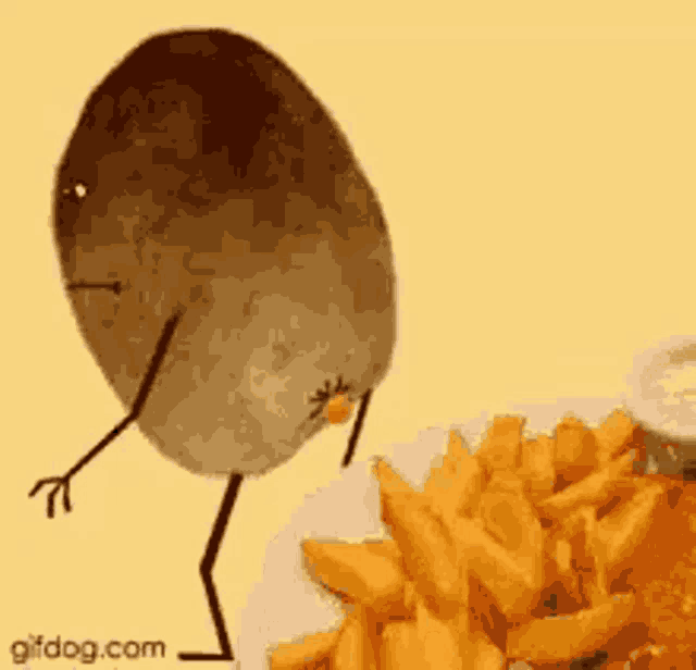 a potato with arms and legs is standing on a plate of french fries .