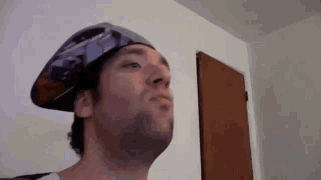 a man wearing a hat with a picture of a plane on it