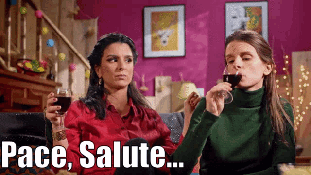 two women sitting on a couch holding wine glasses with the words pace salute written above them
