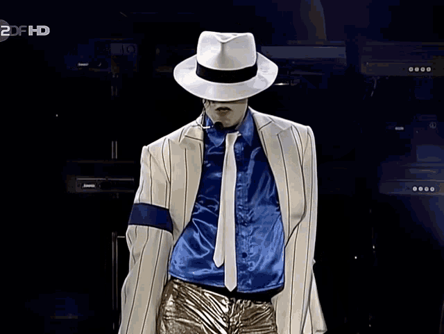 a man wearing a white hat and a blue shirt is dancing on a 2df hd screen