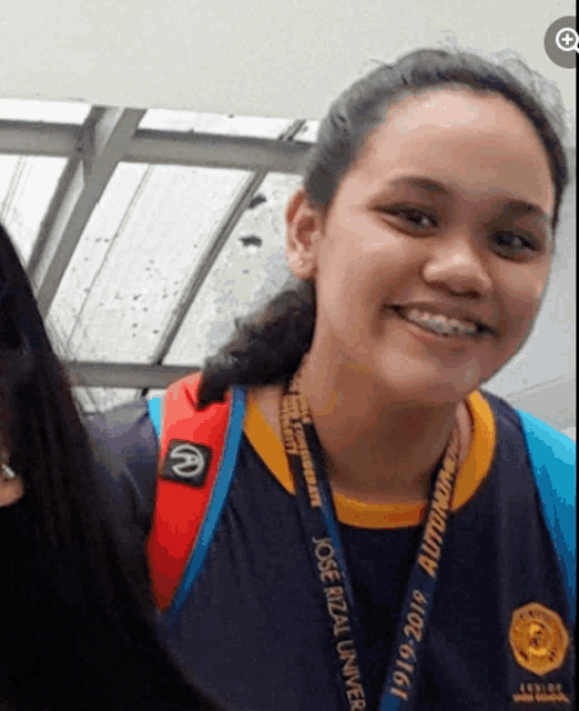 a girl wearing a lanyard that says jose rizal la univer