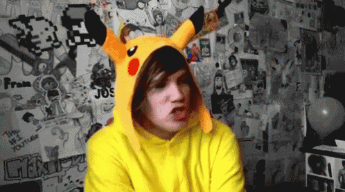 a man wearing a pikachu costume is standing in front of a wall with stickers on it