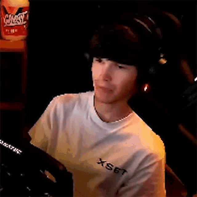 a man wearing headphones and a white shirt says " don 't let me look back "