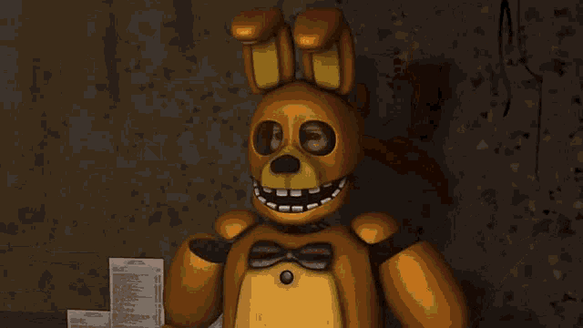 a statue of a bear with a bow on its head
