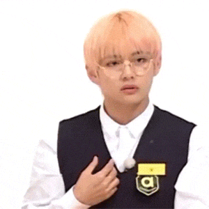 a man with pink hair and glasses is wearing a school uniform and a name tag with the letter a on it .