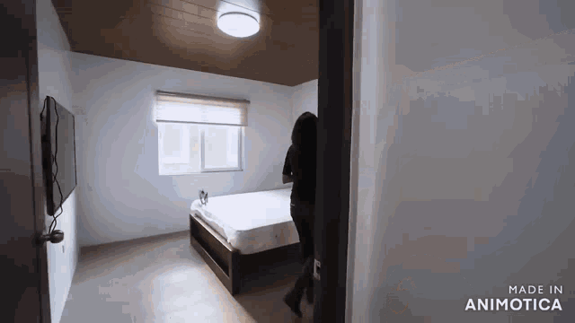 a woman is walking into a bedroom with the words made in animotica on the bottom