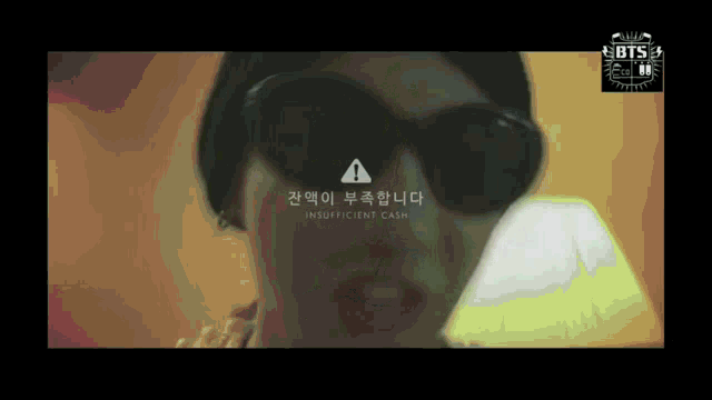 a man wearing sunglasses has a warning sign above his head that reads insufficient cash