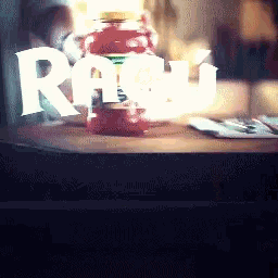 a bottle of rum sits on a table in front of a sign that says raw