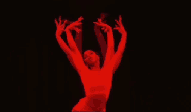 a woman in a blue dress is dancing in the water