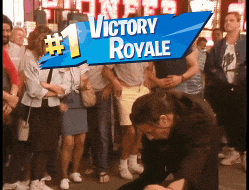 a victory royale sign is above a crowd of people