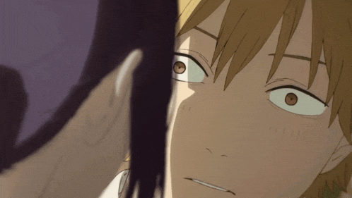 a close up of a man 's face with a woman 's face behind him