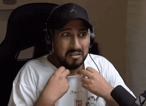 a man with a beard wearing headphones and a white shirt that says you are