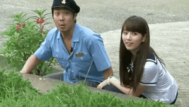 a man in a police uniform is sitting next to a woman in a sailor outfit .