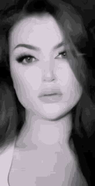 a black and white photo of a beautiful woman with long hair .
