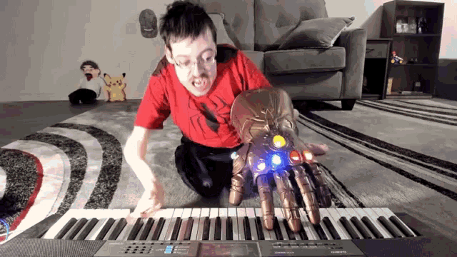 a man in a red shirt playing a piano