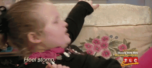 a little girl laying on a couch with the words heel stomp written on the bottom