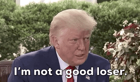 a man in a suit and tie is sitting in a chair and says `` i 'm not a good loser . ''