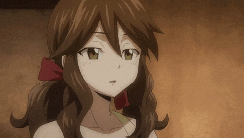 a close up of a girl with brown hair and a red bow
