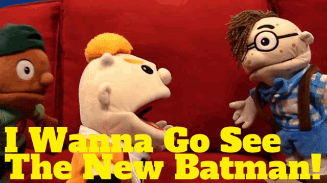 a group of puppets are sitting on a red couch with the words " i wanna go see the new batman " above them