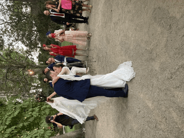 the bride and groom are kissing in front of their wedding guests
