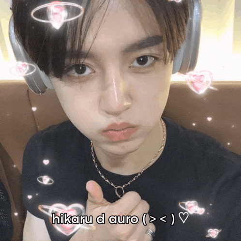 a young man wearing headphones and a necklace with the words hikaru d auro on the bottom