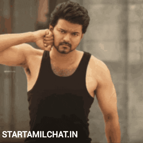 a man in a black tank top is standing in front of a sign that says " starttamilchat.in "