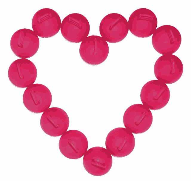 a heart made of pink beads with the letter j in the center