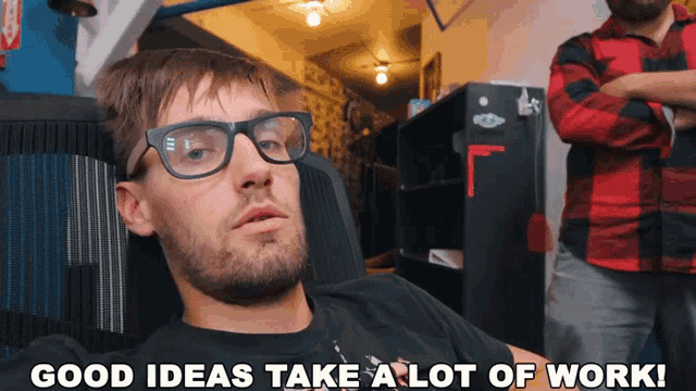 a man with glasses sits in a chair with the words good ideas take a lot of work below him