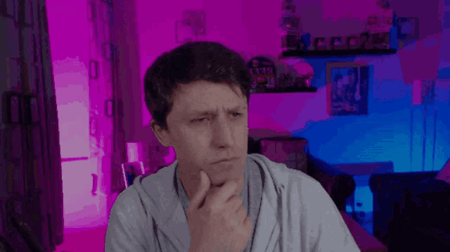 a man in a room with a clock on the wall that says ' clock '