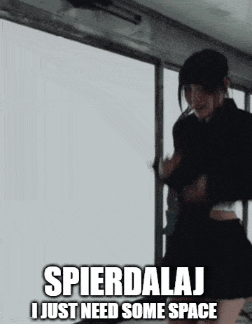 a woman is standing in front of a white board with the words spierdalaj i just need some space written on it