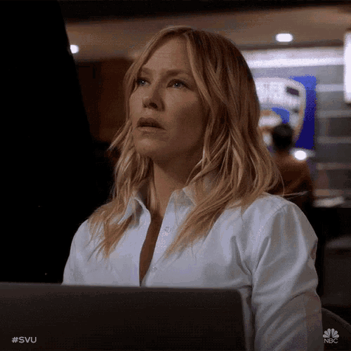 a woman in a white shirt is sitting in front of a laptop with the hashtag #svu