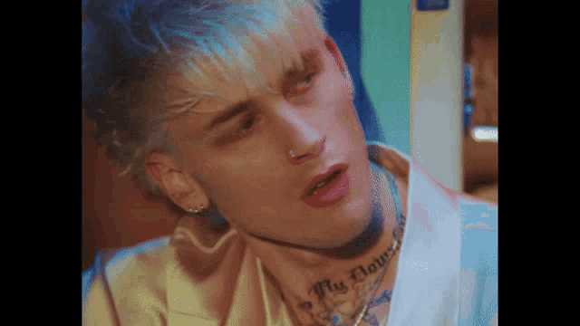 a close up of a man 's face with a tattoo on his neck that says fly damn